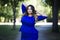 Young beautiful plus size model in blue dress outdoors, xxl woman on nature