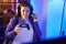 Young beautiful plus size woman streamer playing video game using joystick at gaming room