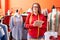 Young beautiful plus size woman tailor smiling confident holding dollars at atelier