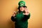 Young beautiful plus size woman wearing green hat celebrating st patricks day drinking beer with open hand doing stop sign with