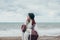 Young beautiful pragnant woman posing near sea at the beach