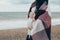 Young beautiful pragnant woman posing near sea at the beach