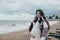 Young beautiful pragnant woman posing near sea at the beach