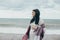 Young beautiful pragnant woman posing near sea at the beach