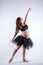 Young beautiful pregnant ballerina with black dress