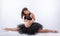 Young beautiful pregnant ballerina with black dress