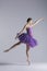 Young beautiful pregnant ballerina is posing in studio