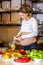 Young beautiful pregnant girl cutting fruits