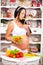 Young beautiful pregnant woman with a plate of fresh vegetable salad.