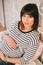 Young beautiful pregnant woman sitting on a bed in a bedroom