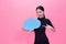 Young beautiful and pretty Asian elegant and stylish woman in black fashion dress holding empty blue bubble talk speech