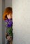 Young beautiful red hair woman holding purple chinese rose copy