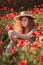 Young beautiful red-hear girl in red poppy field