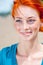 Young beautiful redhead freckled woman smiling