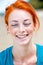 Young beautiful redhead freckled woman smiling