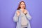 Young beautiful redhead pregnant woman expecting baby over isolated purple background disgusted expression, displeased and fearful