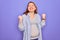 Young beautiful redhead pregnant woman expecting baby over isolated purple background very happy and excited doing winner gesture