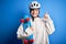 Young beautiful redhead skateboarder woman wearing safety helmet holding skate surprised with an idea or question pointing finger