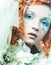 Young beautiful redhead woman with bright creative make-up in New Year& x27;s style. Snow queen, fairy. Close-up portrait