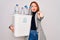 Young beautiful redhead woman recycling holding trash can with plastic bottles to recycle pointing with finger to the camera and