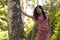 Young beautiful and relaxed Asian Chinese woman in elegant summer dress enjoying serene the beauty of nature leaning dreamy on