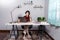A young, beautiful relaxing business asian girl use a laptop working remotely from home on desk as a freelancer, quarantine for