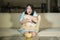 Young beautiful and scared Asian Chinese teenager woman in fear watching horror scary movie at home sofa couch eating popcorn bowl