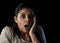 Young beautiful scared Spanish woman in shock and surprise face expression isolated on black