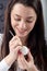 Young beautiful sexy german woman paints a white Easter egg according to Sorbian tradition with a needle head and melted wax