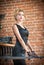 Young beautiful short hair blonde woman in black dress posing . Elegant romantic mysterious lady with movie star look