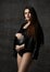 Young beautiful slim pregnant woman with long hair in posing on black background. Pregnancy motherhood, new born life expectation