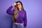 Young beautiful smart woman wearing glasses over purple isolated background pointing unhappy to pimple on forehead, ugly infection