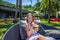 Young beautiful smiling woman holding coconut and relaxing