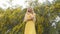 Young beautiful smiling woman in spring Australian Golden wattle trees.