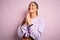 Young beautiful sport woman wearing sweatshirt over pink isolated background begging and praying with hands together with hope