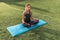 Young beautiful sports girl, fitness woman sitting yoga mat, relaxes meditating, concentration attention, enjoying peace