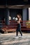 Young beautiful sports girl in sportswear and boxing gloves hits a punching bag in modern black gym.