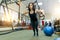 Young beautiful sporty woman exercising on fitness straps system in gym. Fitness, sport, training, and healthy lifestyle concept