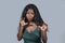 Young beautiful and stressed black African American woman feeling upset and angry gesturing agitated and looking crazy and