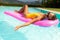 Young Beautiful Suntanned Woman relaxing next to a Swimming Pool