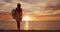 Young beautiful surfer woman standing with surfboard on the beach with the sea