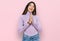 Young beautiful teen girl wearing turtleneck sweater praying with hands together asking for forgiveness smiling confident