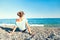 Young beautiful teenage girl contemplating Mediterranean Sea pebble beach