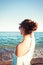 Young beautiful teenage girl looking forward at Mediterranean Sea beach