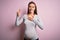 Young beautiful teenager girl pregnant expecting baby over isolated pink background smiling swearing with hand on chest and