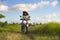 Young beautiful tourist or nomad traveler black afro American woman riding motorbike in tropical field wearing traditional Asian h