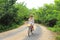 Young beautiful tourist riding a bike in the sand roads of Bocas del Toro islands in PanamÃ¡