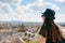 Young beautiful travel girl with a backpack on top of a hill in Cappadocia, Turkey. Travel, success, freedom