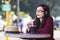 Young beautiful traveler enjoying a coffee at street cafe