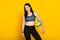 Young beautiful volleyball player isolated on yellow in studio